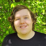 young man with long dirty blonde hair and a blue shirt